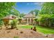 Beautiful home featuring a well-manicured lawn, patio, and lush trees creating a private backyard retreat at 517 Kingsdown Ct, Waxhaw, NC 28173