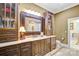 Beautiful bathroom features a large framed mirror and wooden cabinetry for ample storage at 517 Kingsdown Ct, Waxhaw, NC 28173