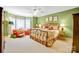 Comfortable bedroom with natural light, colorful decor, and a plush seating area at 517 Kingsdown Ct, Waxhaw, NC 28173