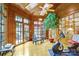 Bright exercise room with wood ceilings and walls, offering views of the outdoor at 517 Kingsdown Ct, Waxhaw, NC 28173