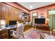 Well-appointed home office with custom built-ins, dual monitors, and cozy rug at 517 Kingsdown Ct, Waxhaw, NC 28173