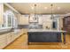 Gourmet kitchen with a large center island, custom cabinets and stainless steel appliances for modern appeal at 517 Kingsdown Ct, Waxhaw, NC 28173