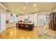 Bright and airy kitchen showcasing a center island, farmhouse sink, custom cabinetry and hardwood flooring at 517 Kingsdown Ct, Waxhaw, NC 28173