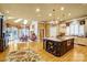 Open kitchen featuring a large center island, hardwood floors, chandeliers and a breakfast nook perfect for gatherings at 517 Kingsdown Ct, Waxhaw, NC 28173