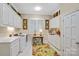 Bright laundry room featuring white cabinetry, a utility sink, and a floral accent rug at 517 Kingsdown Ct, Waxhaw, NC 28173