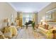 Inviting living room with piano, comfortable seating, and ample natural light from large windows at 517 Kingsdown Ct, Waxhaw, NC 28173