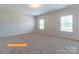 Large bedroom with neutral carpet, plenty of light from the two windows, and neutral-colored walls at 524 Hullview Vis, Monroe, NC 28110