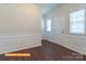 Bright foyer featuring wainscoting, luxury vinyl flooring, and a white front door flanked by two windows at 524 Hullview Vis, Monroe, NC 28110