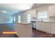 Modern kitchen with granite island, stainless steel appliances and white cabinets and view of living room at 524 Hullview Vis, Monroe, NC 28110