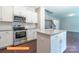 Gourmet kitchen with granite counters, stainless appliances, ample cabinet space, and adjacent staircase at 524 Hullview Vis, Monroe, NC 28110
