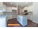 Modern kitchen with white cabinets, stainless steel appliances, and a granite island countertop at 524 Hullview Vis, Monroe, NC 28110