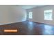 Bright living room features wood flooring, neutral walls, and natural light from the two windows at 524 Hullview Vis, Monroe, NC 28110