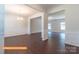 Open-concept living area with dark luxury vinyl flooring, wainscoting, chandelier and views to the next room at 524 Hullview Vis, Monroe, NC 28110