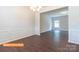 Spacious open-concept room with chandelier, wainscoting, luxury vinyl flooring and an open layout at 524 Hullview Vis, Monroe, NC 28110