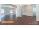 Expansive living space with luxury vinyl flooring, wainscoting, and an open layout connecting multiple rooms at 524 Hullview Vis, Monroe, NC 28110