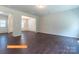 Spacious open-concept dining and living area with dark floors, wainscoting, recessed lighting, and natural light at 524 Hullview Vis, Monroe, NC 28110