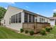 Wooden deck featuring seating, a partial awning, and greenery surrounding the back of the property at 56113 Finches Ct, Indian Land, SC 29707