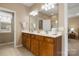 Bathroom with double vanity, a large mirror, and cabinets for storage at 56113 Finches Ct, Indian Land, SC 29707
