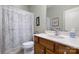 Bathroom featuring a toilet, vanity with wood cabinets and shower with patterned curtain at 56113 Finches Ct, Indian Land, SC 29707