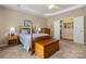 Bedroom featuring a wood-framed bed, blue bedding, and a tray ceiling at 56113 Finches Ct, Indian Land, SC 29707