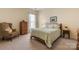 Comfortable bedroom with neutral walls and carpet, including a cozy armchair at 56113 Finches Ct, Indian Land, SC 29707