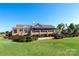 The Club at Longview's clubhouse with a patio, landscaping, and blue skies at 56113 Finches Ct, Indian Land, SC 29707