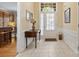 Warm and inviting entryway featuring neutral tile flooring, a decorative table, and an arched doorway at 56113 Finches Ct, Indian Land, SC 29707