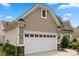 Exterior elevation of a home featuring a white garage door and stone veneer at 56113 Finches Ct, Indian Land, SC 29707