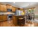 A kitchen featuring stainless steel appliances, wooden cabinets, a breakfast nook, and a kitchen island at 56113 Finches Ct, Indian Land, SC 29707