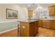 A kitchen featuring a wooden island with a granite countertop, cabinet space, and hardwood flooring at 56113 Finches Ct, Indian Land, SC 29707