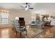 Spacious living room featuring hardwood floors, comfortable seating, and an open layout to the dining area at 56113 Finches Ct, Indian Land, SC 29707