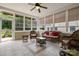 A sunroom featuring tiled floors, a ceiling fan, and wicker furniture at 56113 Finches Ct, Indian Land, SC 29707