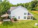Aerial view of a two story home with a well-manicured lawn, lush landscaping, and bright white siding at 5963 Pale Moss Ln, Charlotte, NC 28269