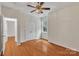 Empty bedroom boasts hardwood floors, ceiling fan and a double door closet at 5963 Pale Moss Ln, Charlotte, NC 28269