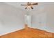Empty bedroom boasts hardwood floors, ceiling fan and a double door closet at 5963 Pale Moss Ln, Charlotte, NC 28269