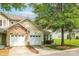 Charming home with stone accents, a two-car garage, and lush landscaping on a sunny day at 5963 Pale Moss Ln, Charlotte, NC 28269