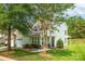 Charming home with manicured lawn, lush landscaping and neutral siding on a bright sunny day at 5963 Pale Moss Ln, Charlotte, NC 28269