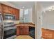 Well-equipped kitchen with stainless steel appliances and wood cabinetry at 5963 Pale Moss Ln, Charlotte, NC 28269