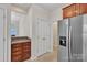 Kitchen with stainless steel refrigerator, cabinets, and access to other rooms at 5963 Pale Moss Ln, Charlotte, NC 28269
