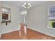 Open-concept living room with hardwood floors and great natural light creates a warm and inviting space at 5963 Pale Moss Ln, Charlotte, NC 28269