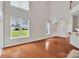 Bright living room boasts hardwood floors, large windows, and open floor plan at 5963 Pale Moss Ln, Charlotte, NC 28269
