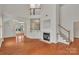 Spacious living room boasts hardwood floors, a fireplace, and an open staircase leading to the second floor at 5963 Pale Moss Ln, Charlotte, NC 28269