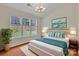 Comfortable main bedroom featuring a bed, large windows and stylish decor at 5963 Pale Moss Ln, Charlotte, NC 28269