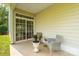 Covered patio with tile flooring, stylish seating, and sliding glass doors leading to the interior at 5963 Pale Moss Ln, Charlotte, NC 28269