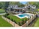 Aerial shot of backyard showcasing the pool, spa, patio, and lush landscaping at 639 Edgemont Rd, Charlotte, NC 28211