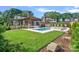 Expansive backyard featuring a pool, spa, outdoor seating, and lush landscaping, perfect for relaxation and entertainment at 639 Edgemont Rd, Charlotte, NC 28211