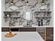 Stylish bar area featuring marble backsplash, floating shelves, and a wine refrigerator for entertaining at 639 Edgemont Rd, Charlotte, NC 28211