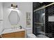Modern bathroom with black herringbone shower, wooden vanity, and stylish fixtures at 639 Edgemont Rd, Charlotte, NC 28211