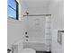 Modern bathroom showcasing herringbone tile, a soaking tub, and sleek black fixtures at 639 Edgemont Rd, Charlotte, NC 28211