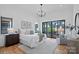 Bright and airy bedroom with hardwood floors, large windows, and access to a private outdoor space at 639 Edgemont Rd, Charlotte, NC 28211